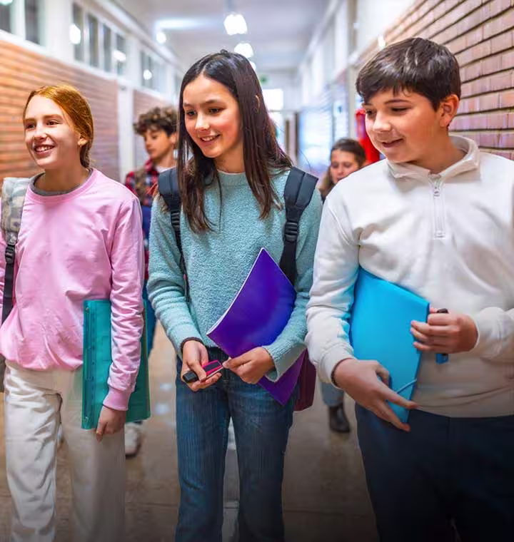 students-holding-folders-in-school-hallway